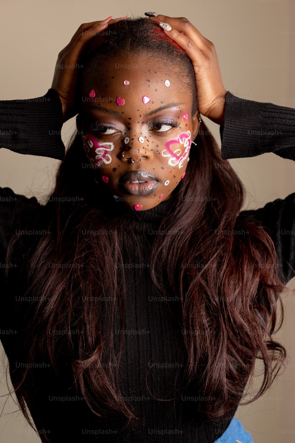 a woman with her face painted with pink and white sprinkles