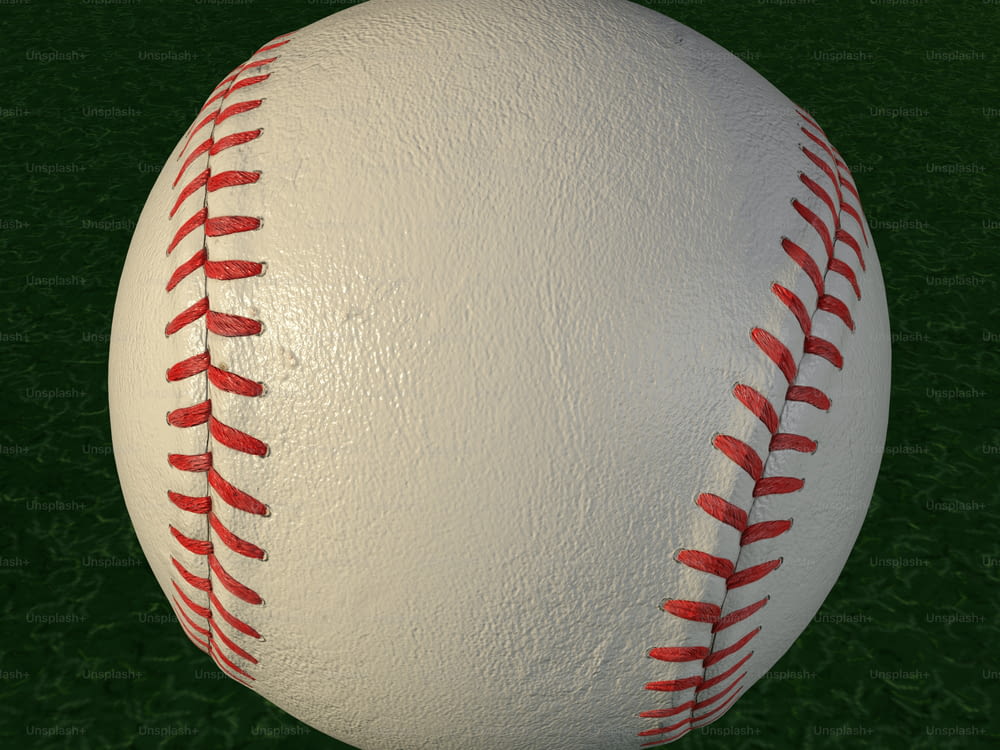 a close up of a baseball on a green field