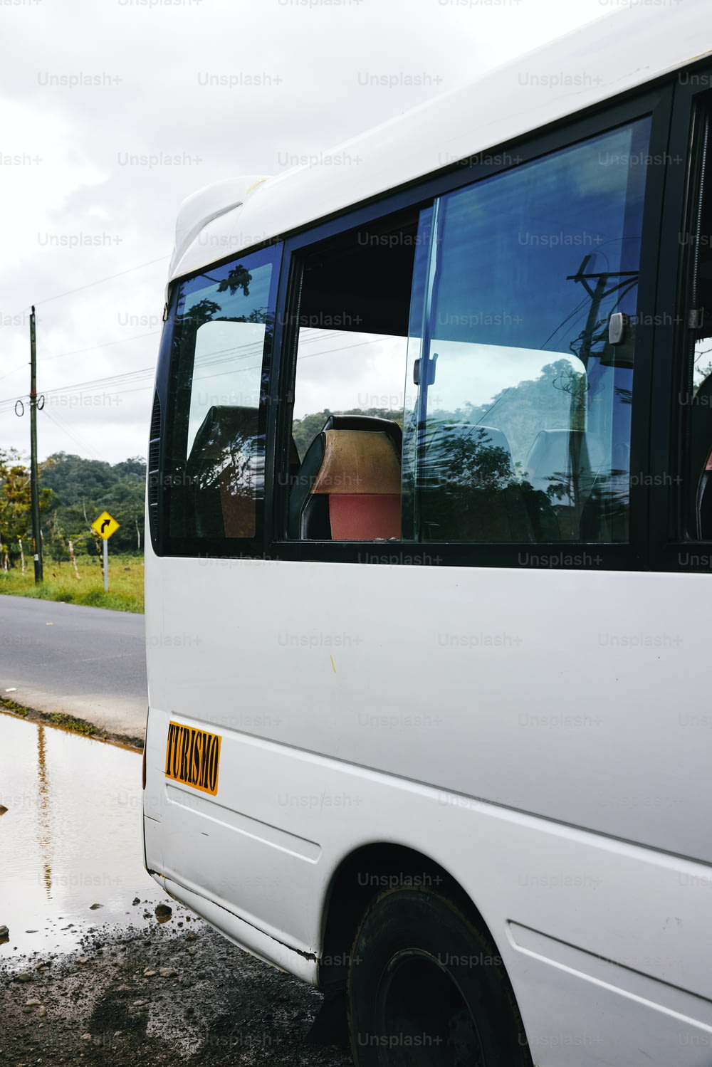 a white bus parked on the side of the road
