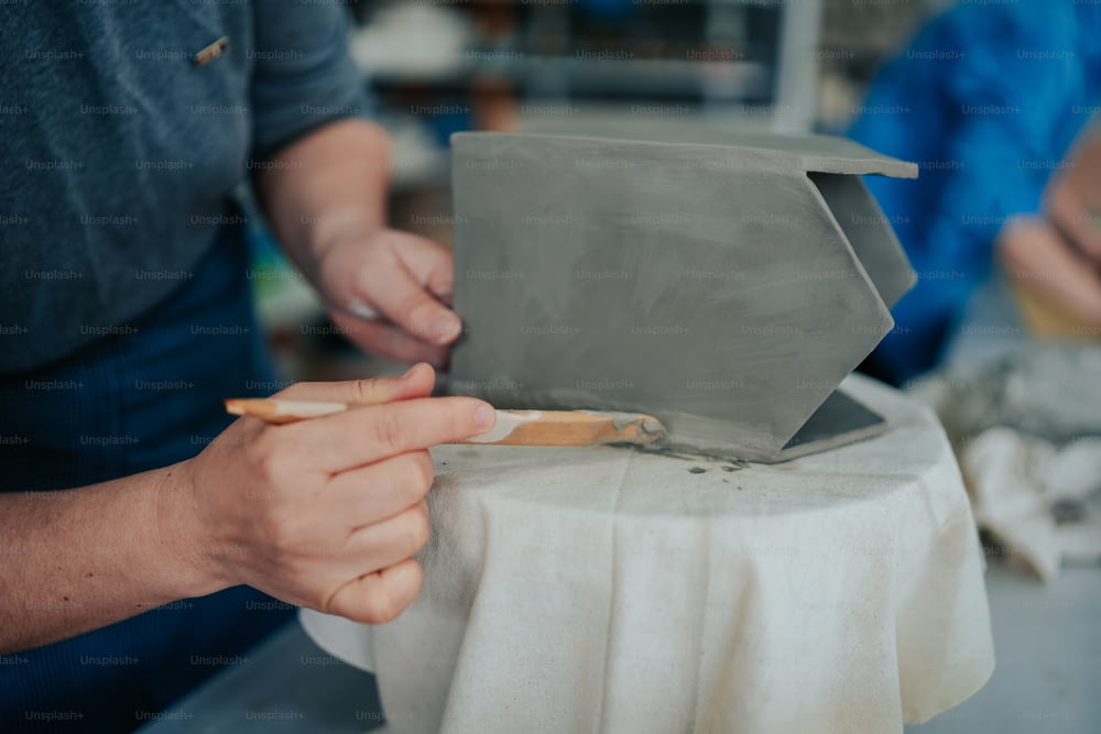 a person using a knife to cut a piece of paper