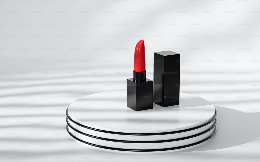 a red lipstick sitting on top of a white table