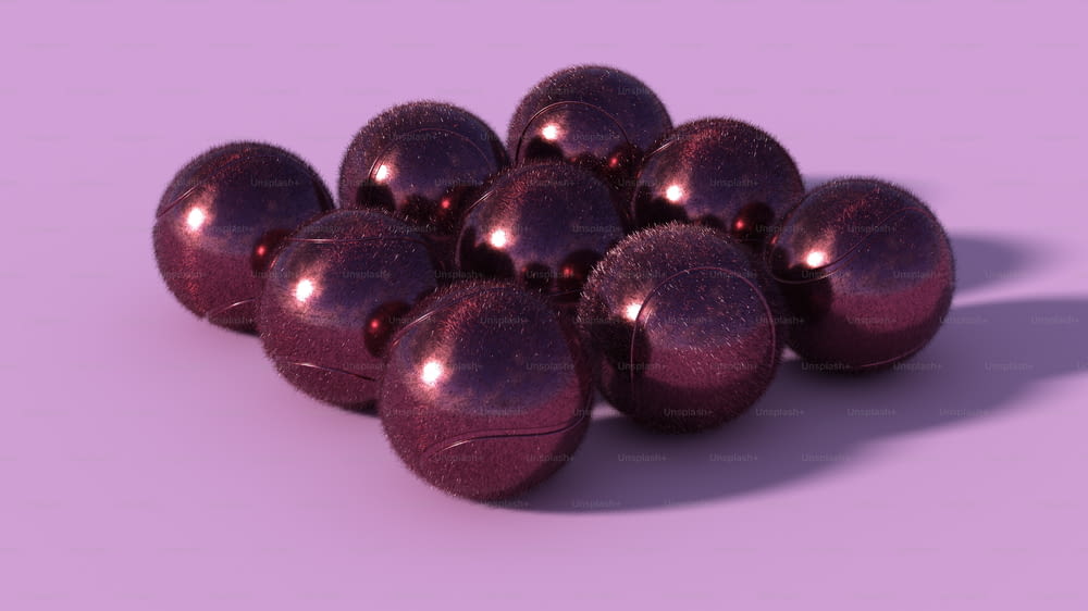 a pile of shiny purple balls on a purple background