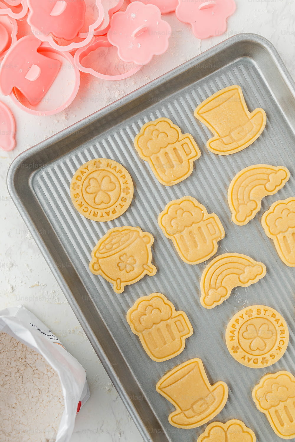 a cookie sheet with cookie cutters on it