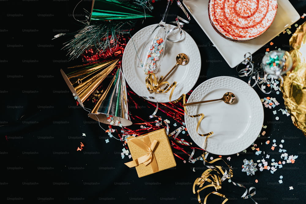 a table topped with plates of food and confetti
