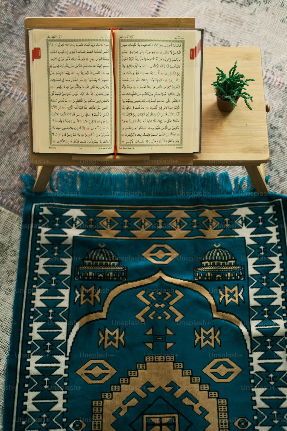 an open book sitting on top of a blue rug