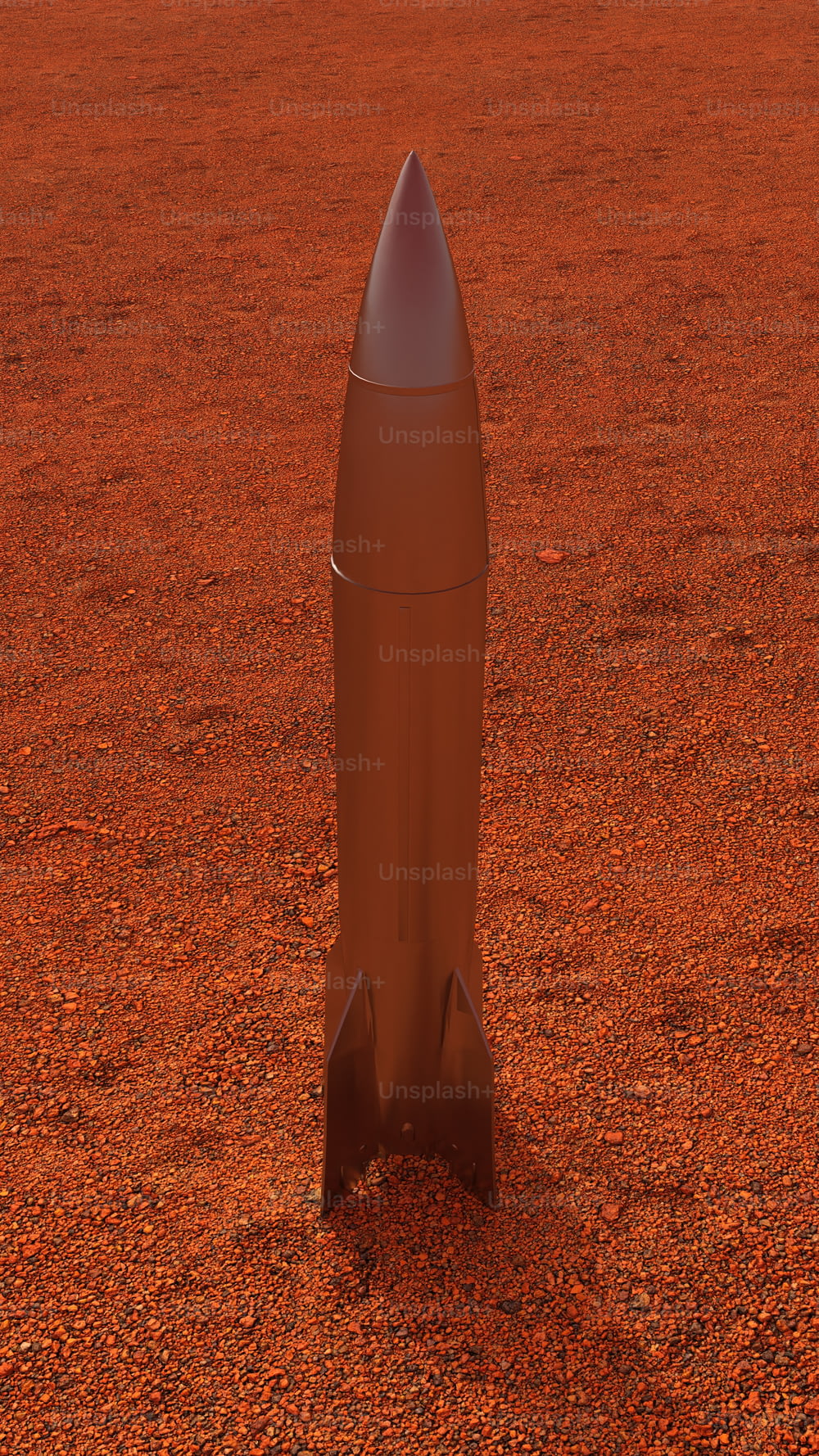 a small rocket sitting on top of a dirt field