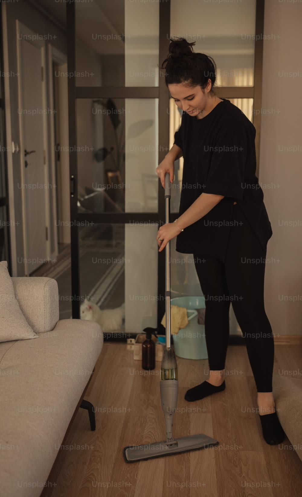 a woman with a mop is cleaning the floor