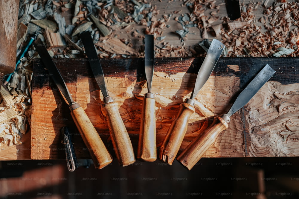 Un gruppo di coltelli seduti sopra un tavolo di legno