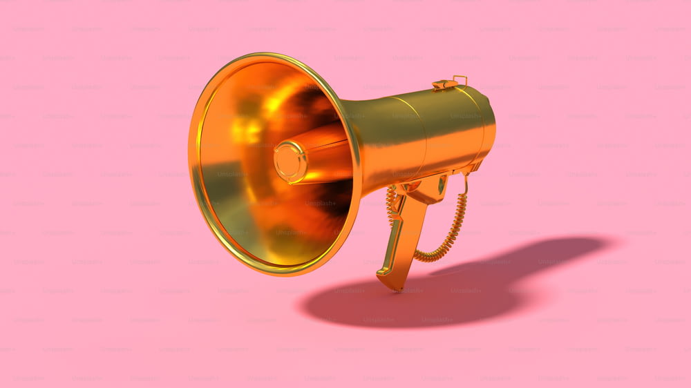 Un mégaphone doré sur fond rose