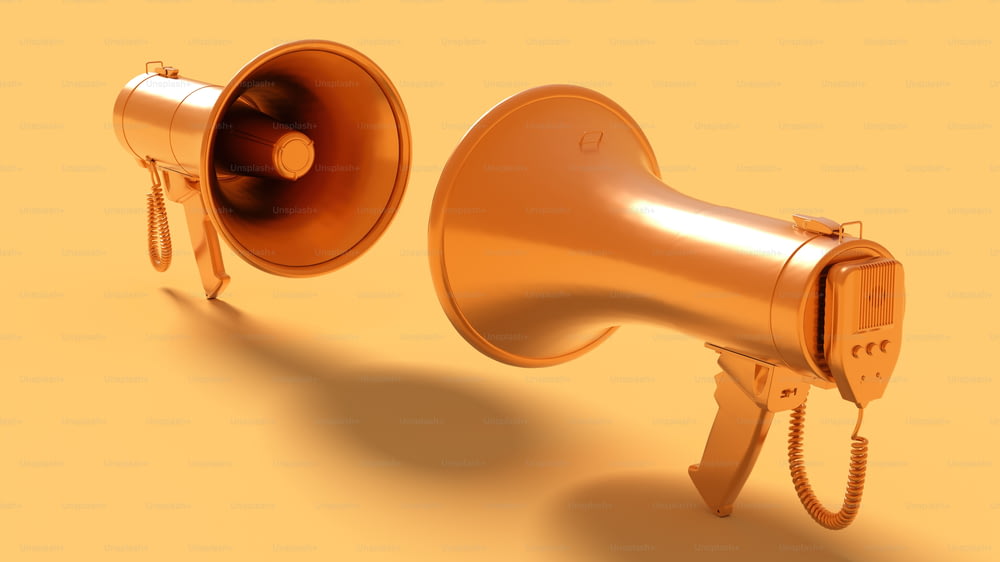 a gold megaphone and a gold speaker on a yellow background