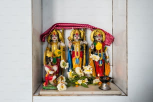 a group of statues of hindu deities in a niche