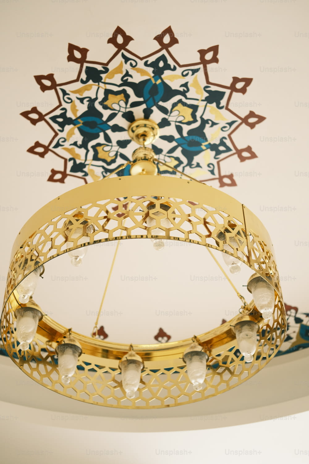 a gold and blue chandelier hanging from a ceiling