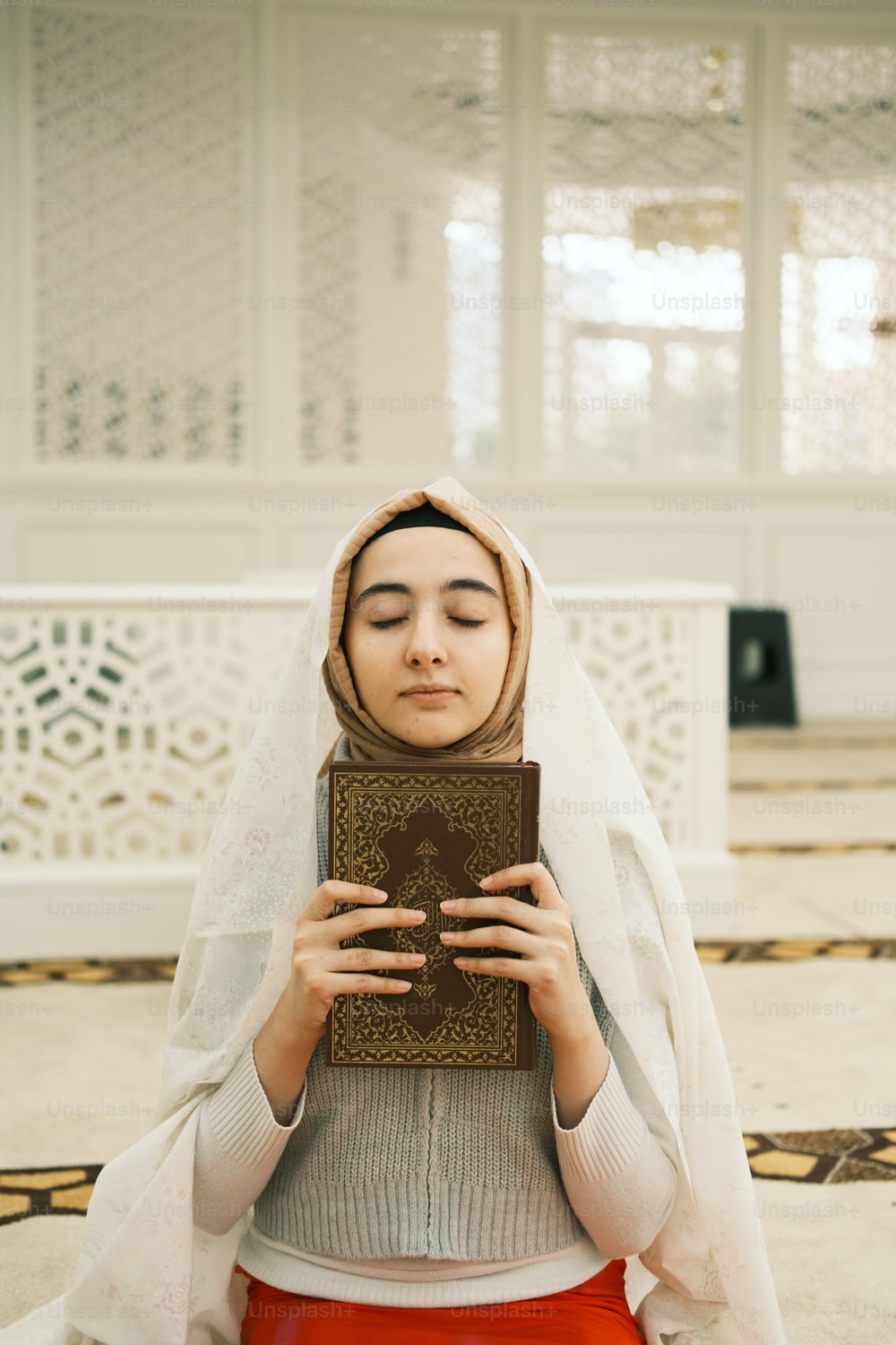 a woman in a veil holding a book