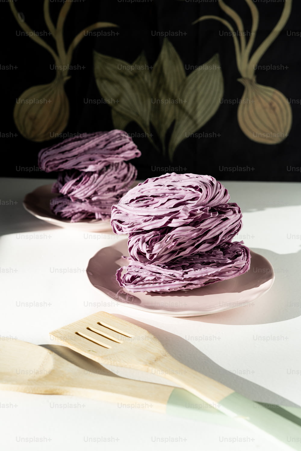 a plate of purple cake next to a fork