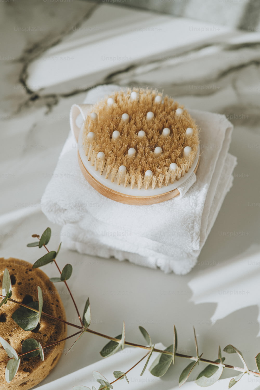a brush sitting on top of a towel next to a cookie