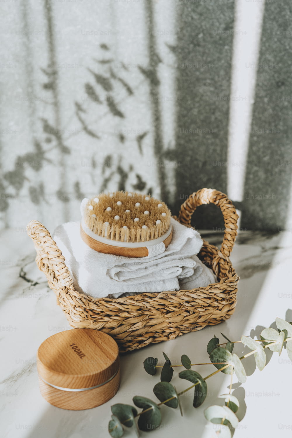 a wicker basket with a wooden brush on top of it
