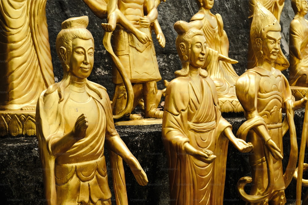 a group of carved wooden statues sitting next to each other