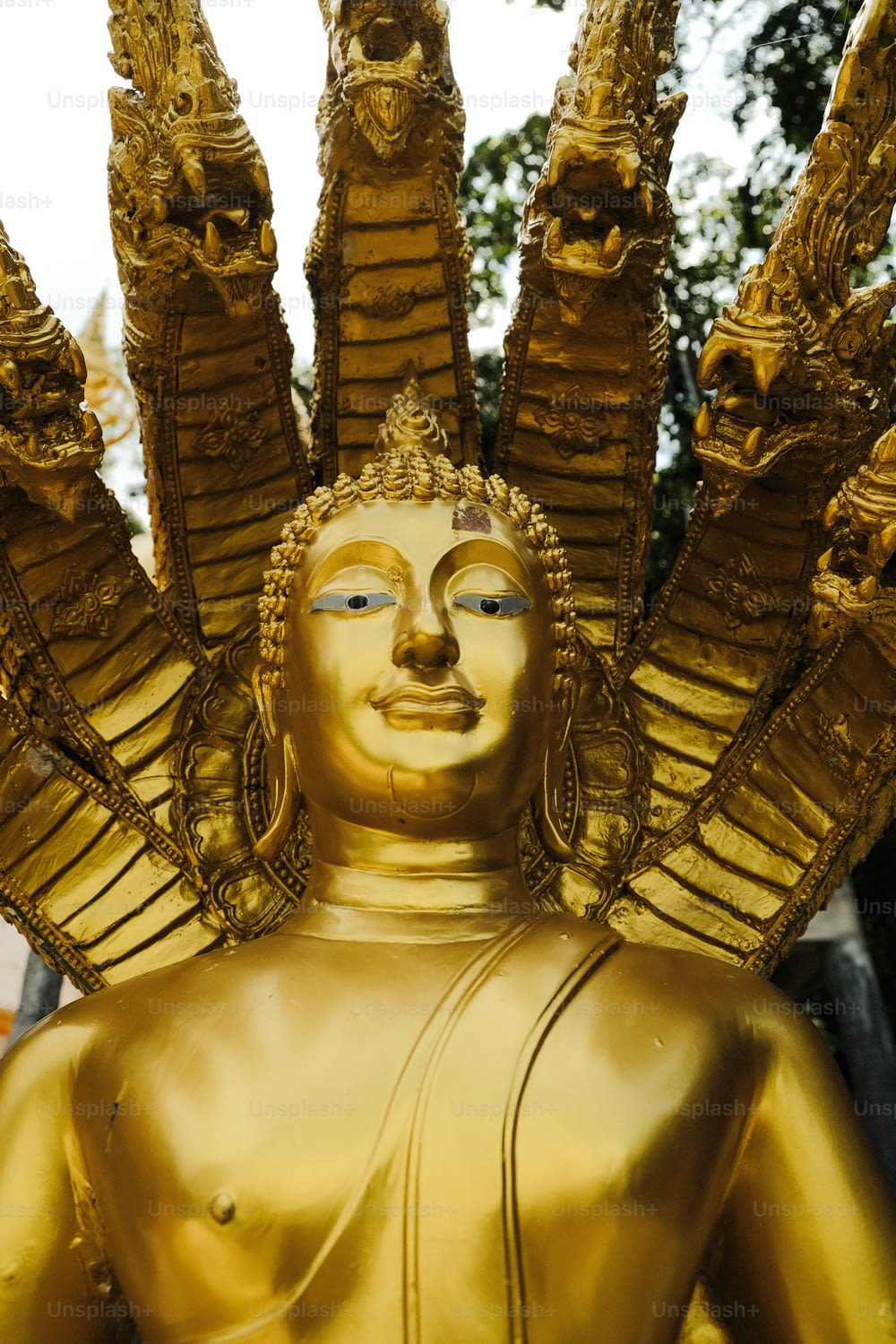 a golden statue of a person with many arms outstretched
