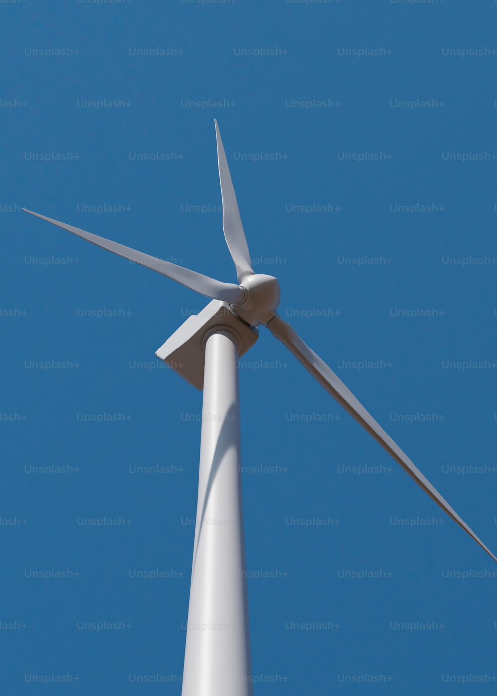 a white wind turbine against a blue sky