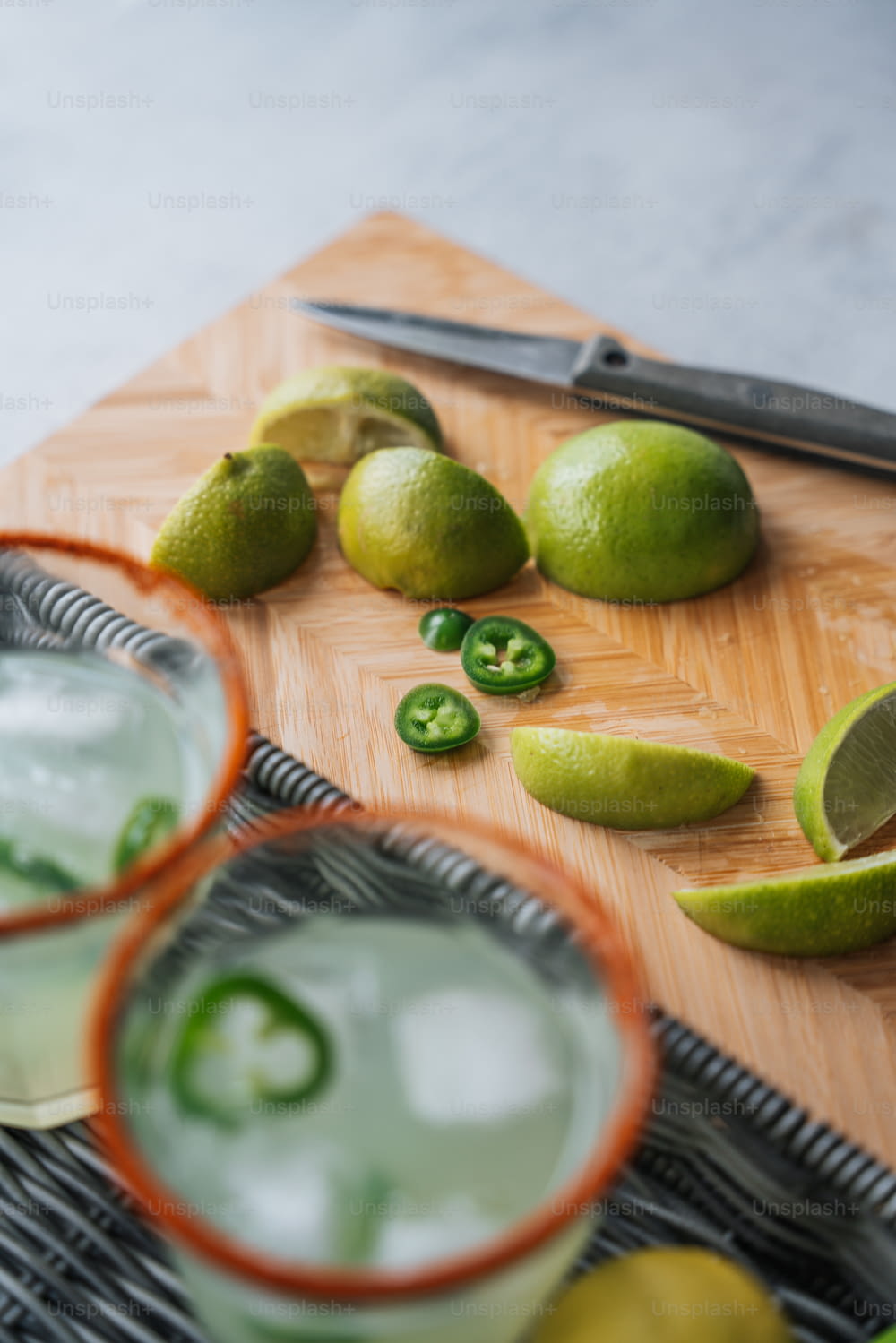 a cutting board topped with limes and limeade