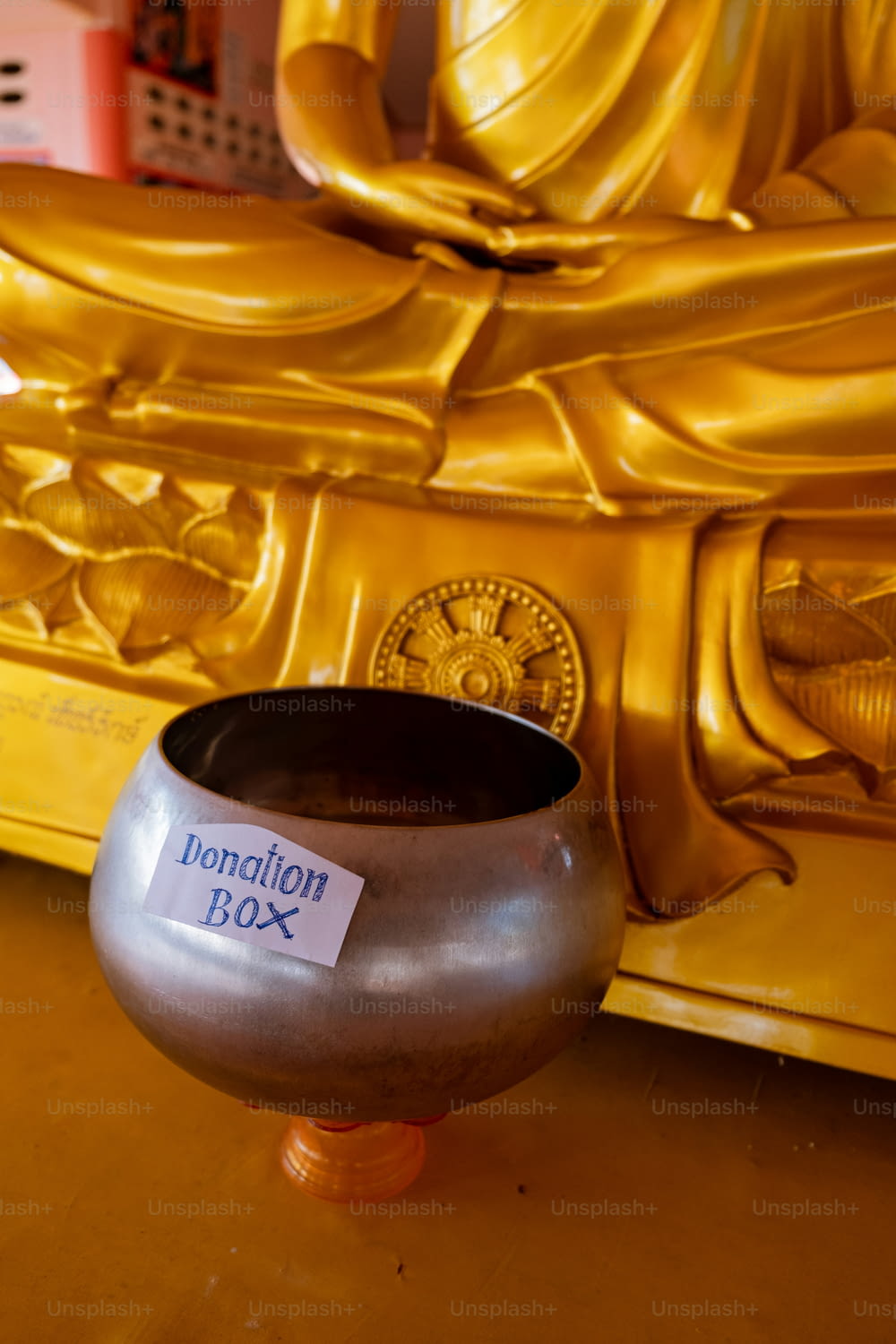 a silver bowl sitting on top of a wooden table