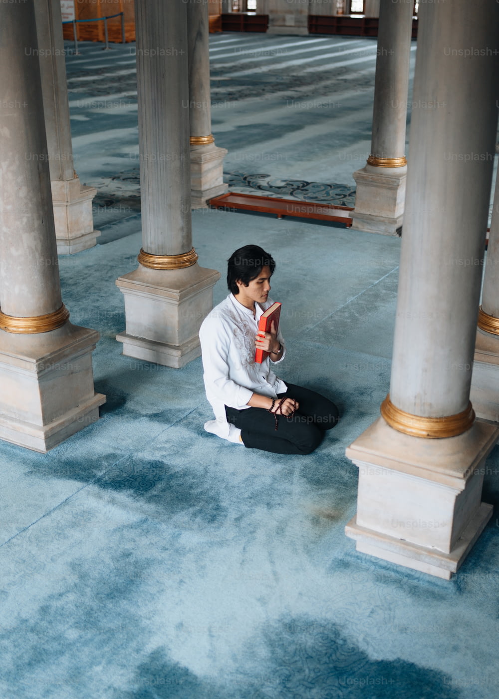 a woman sitting on the floor in a building