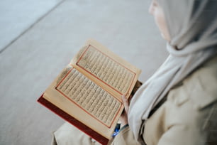 a woman in a hijab holding a book