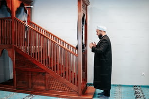 a man standing in front of a wooden staircase
