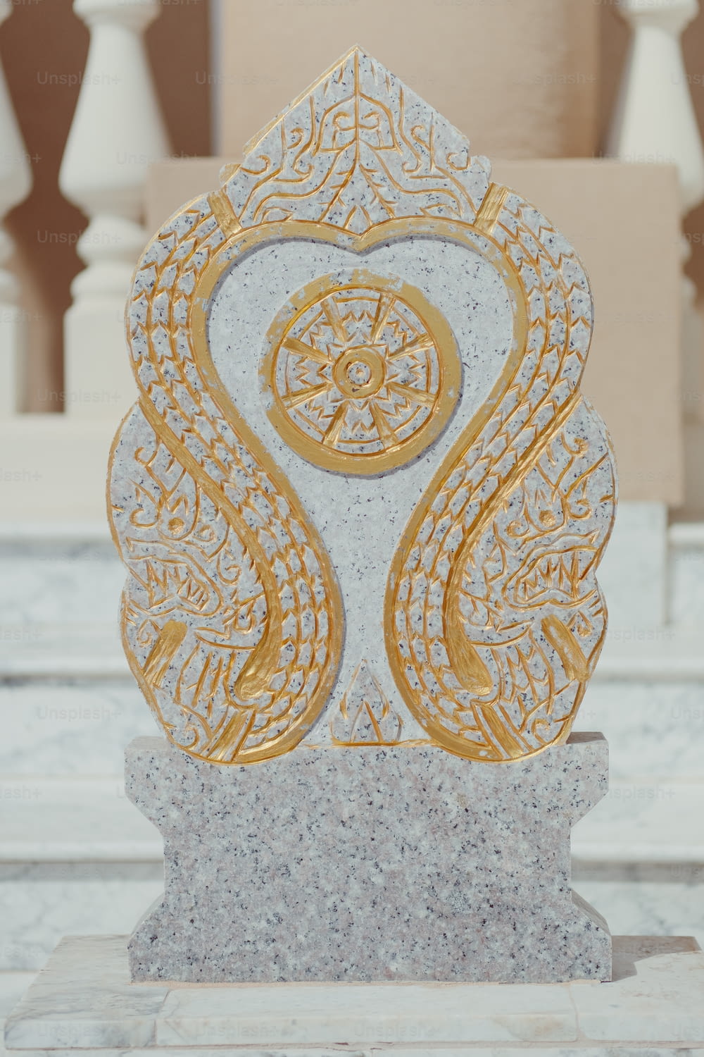a marble statue with a gold design on it