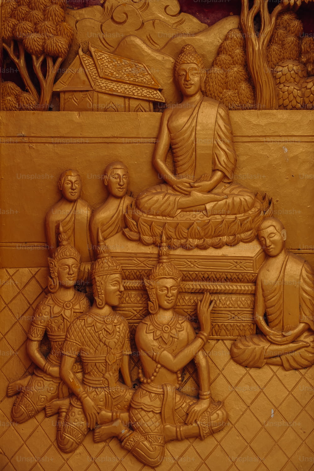 a carving of a buddha statue surrounded by other statues