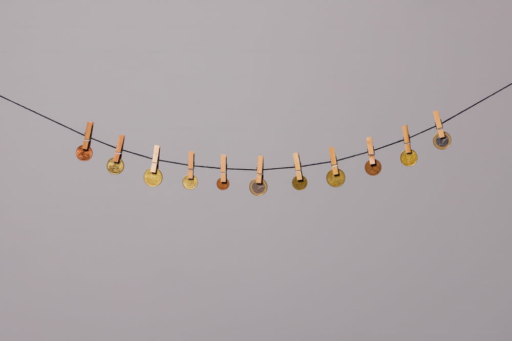 a row of clothes pins hanging from a clothes line