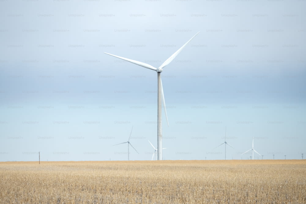 a wind farm with several windmills in the distance