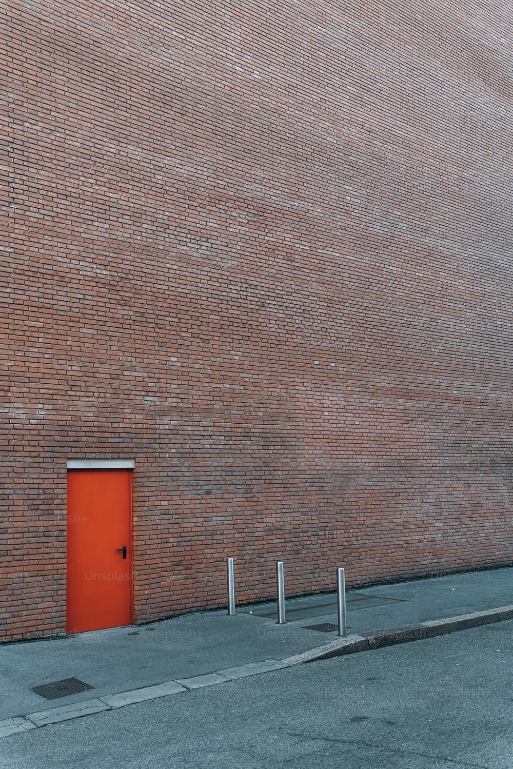 a brick building with a red door on the side of it
