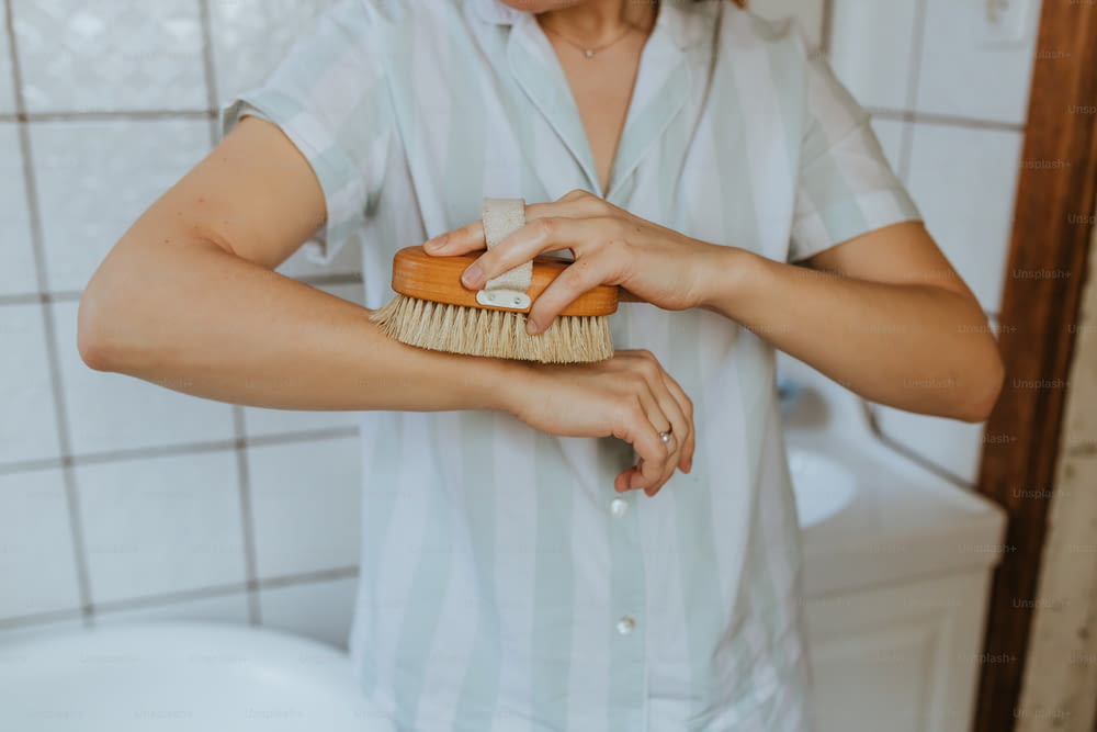 Una mujer se cepilla el pelo con un cepillo