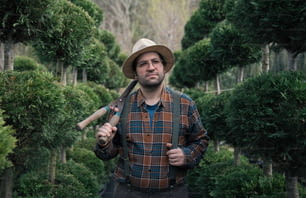 a man holding a baseball bat and wearing a hat