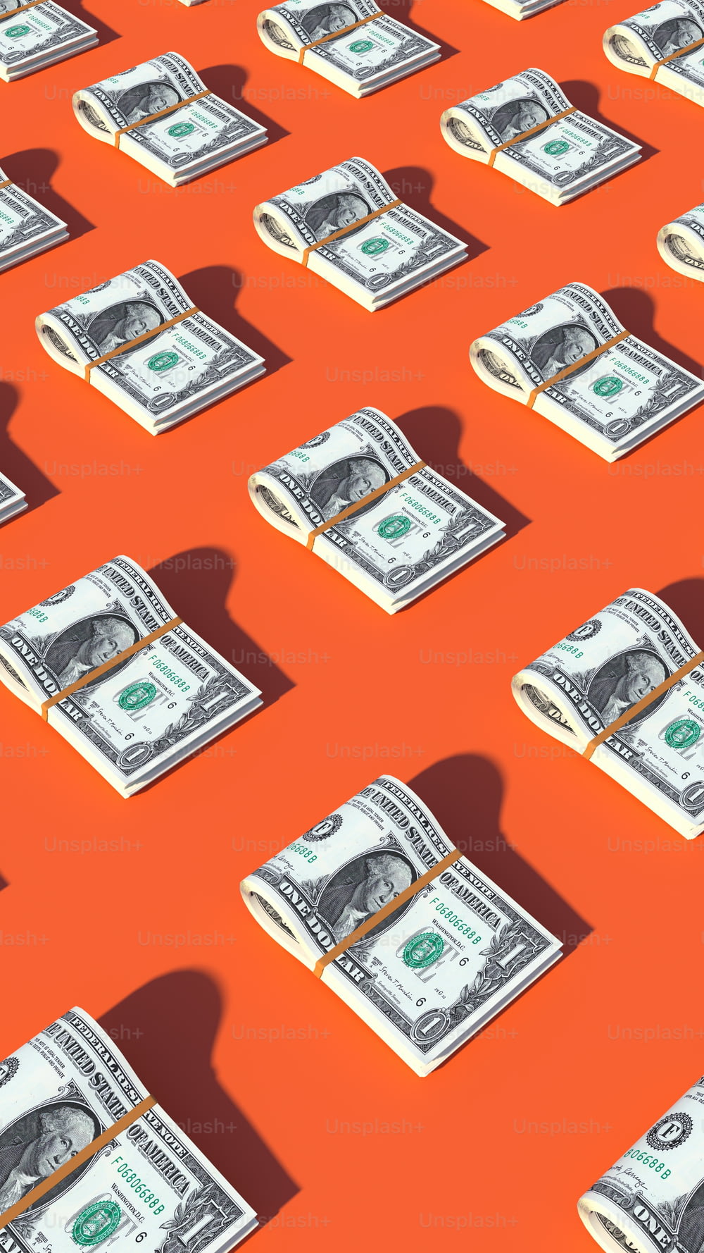 a bunch of money sitting on top of an orange surface