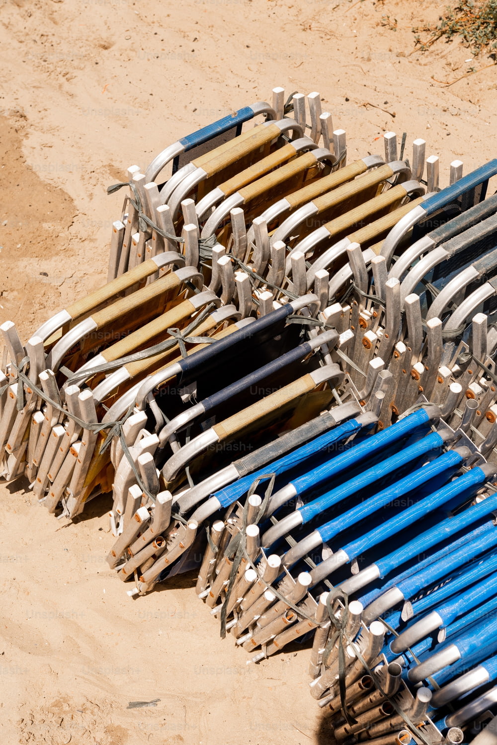a bunch of chairs that are sitting in the sand