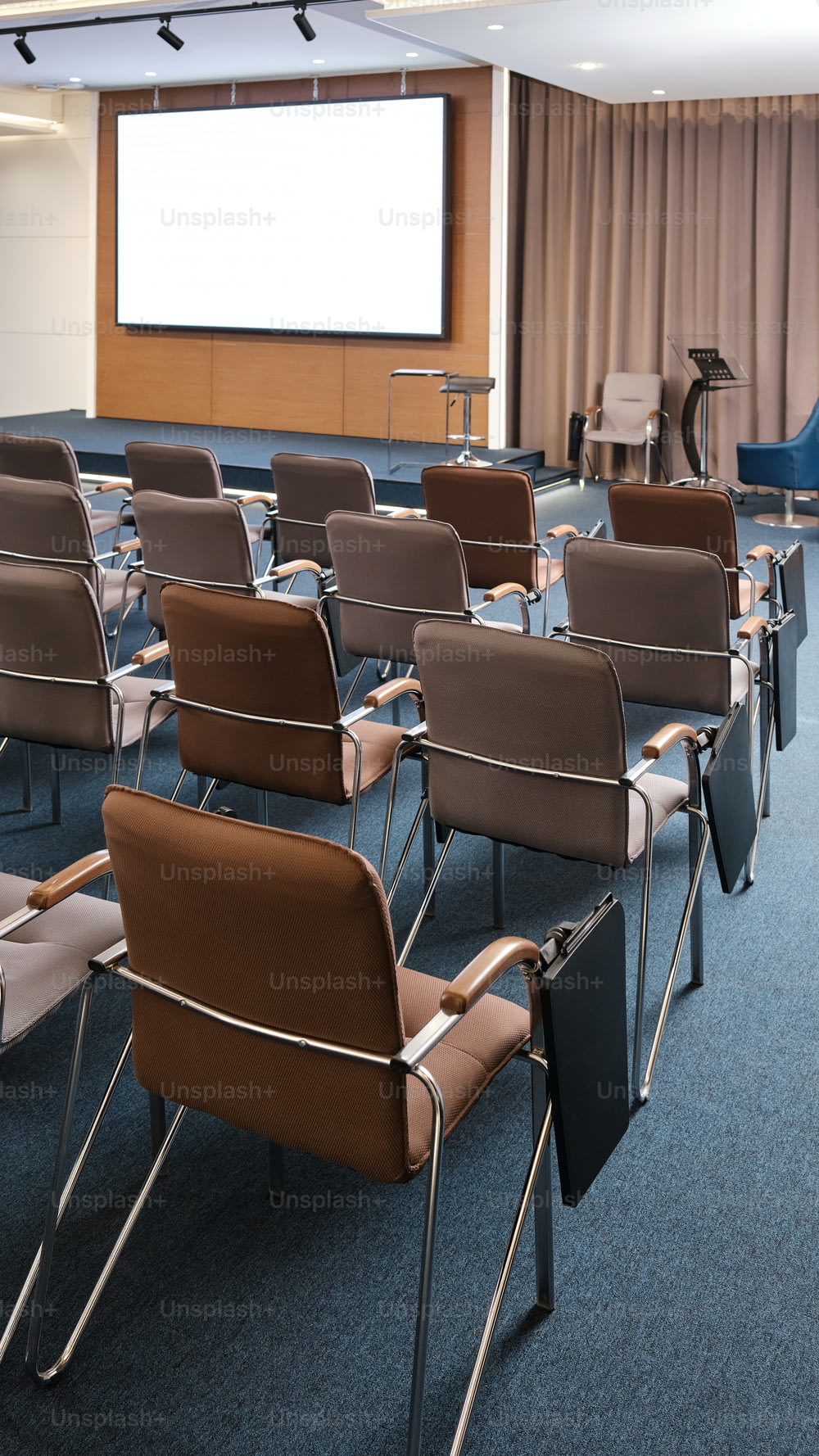 a room filled with chairs and a projector screen