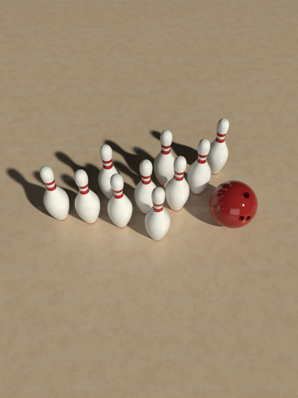 a group of bowling pins and a red ball