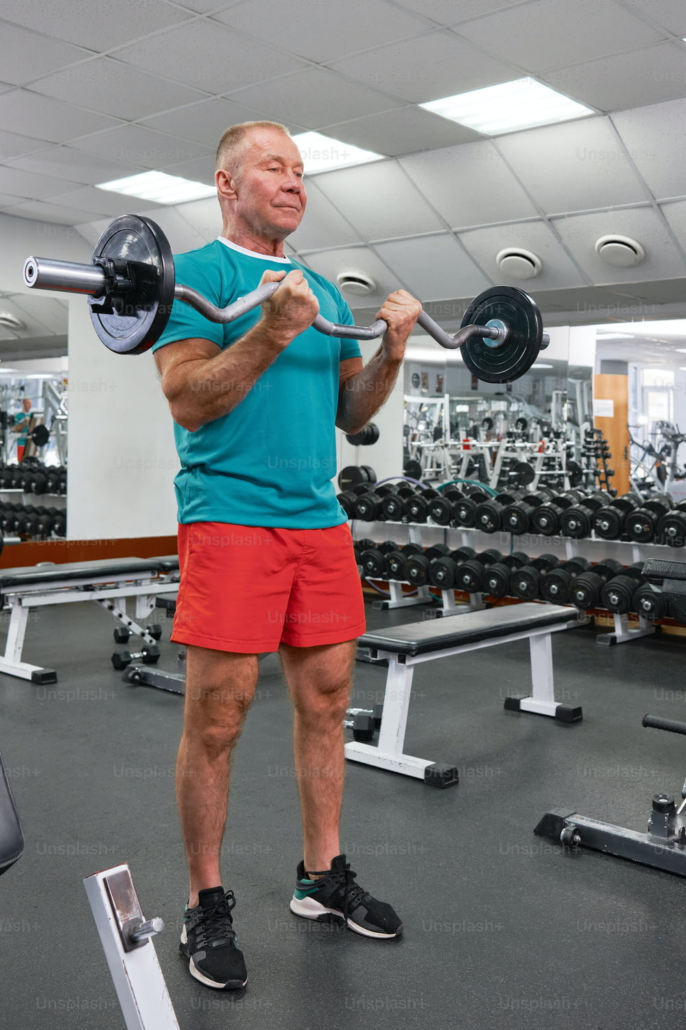 a man in a gym holding a barbell
