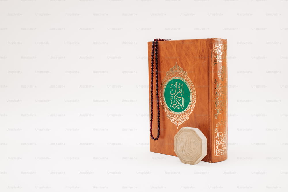 a wooden book with a green and gold cover