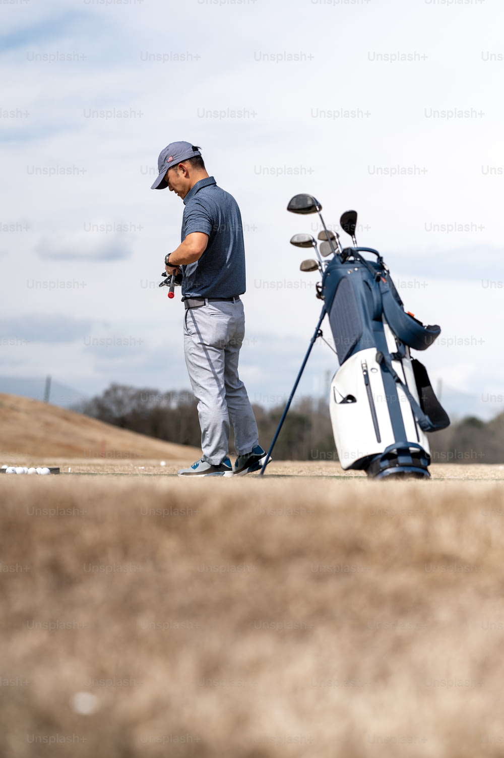 a man standing next to a golf bag