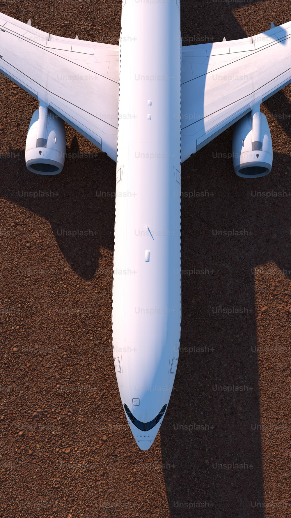 흙밭 위에 앉아 있는 커다란 흰색 비행기
