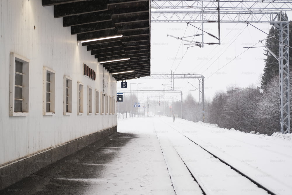 a train station with snow on the ground