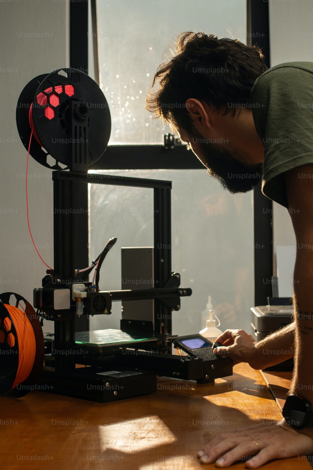 a man is working on a 3d printer