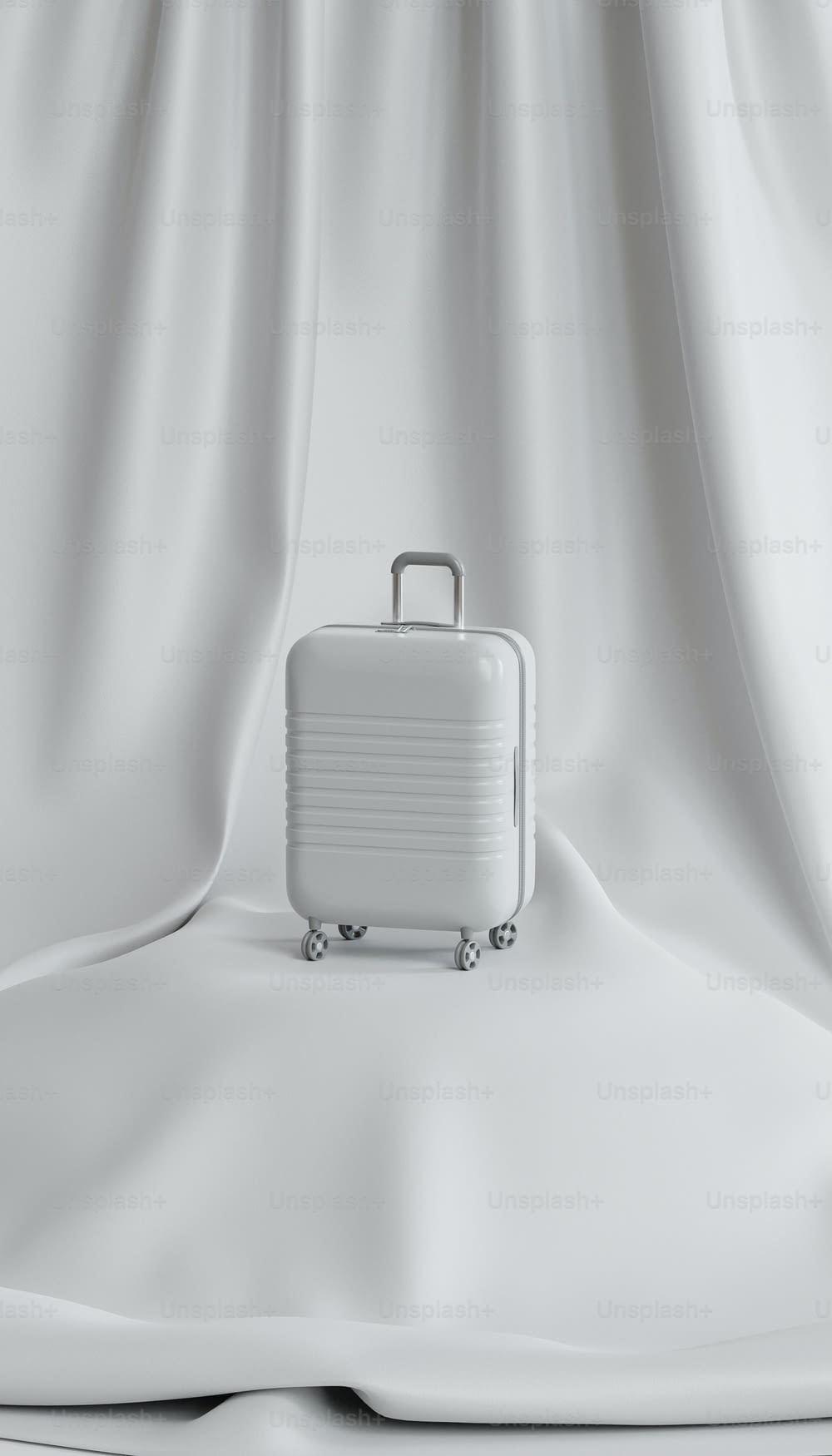 a white suitcase sitting on top of a white sheet
