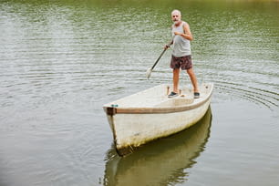 a man paddles a boat on a lake