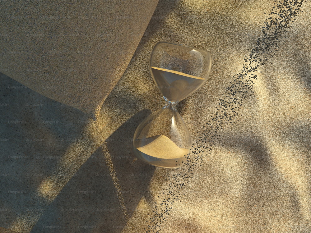 砂に覆われた地面の上に座る砂時計