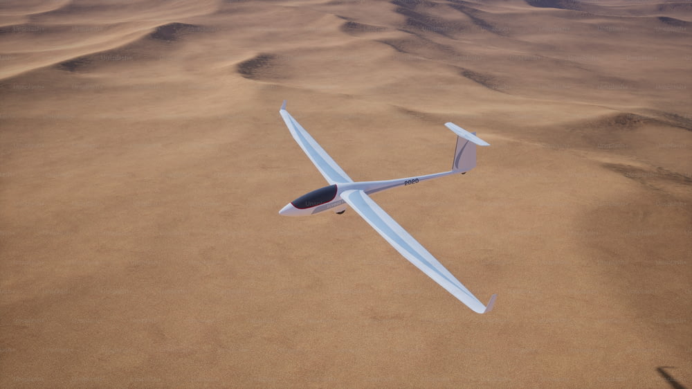 砂浜の砂漠の上を飛ぶ小さな飛行機