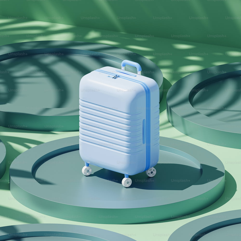 a blue suitcase sitting on top of a green floor